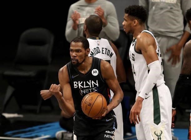 Kevin Durant of the Brooklyn Nets celebrates after he drew the foul as Giannis Antetokounmpo of the Milwaukee Bucks reacts in the fourth quarter...