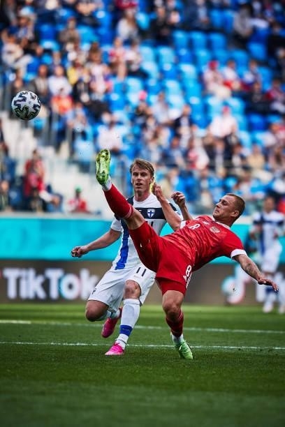 Dmitri Barinov of Russia kicks the ball against Rasmus Schüller of Finland during the UEFA Euro 2020 Championship Group B match between Finland and...