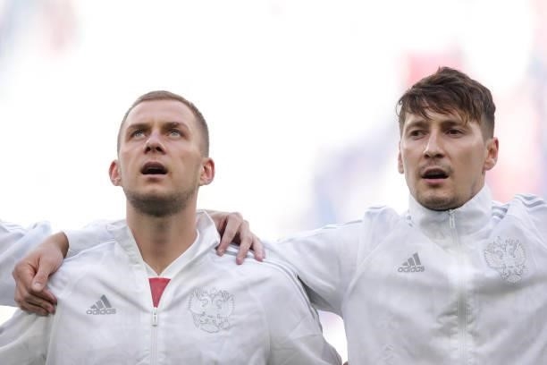 Dmitri Barinov of Russia and his teammate Daler Kuzyaev sing their national anthem prior to start the UEFA Euro 2020 Championship Group B match...