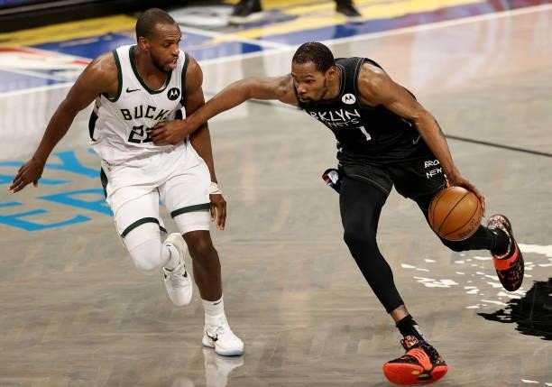 Kevin Durant of the Brooklyn Nets drives around Khris Middleton of the Milwaukee Bucks in the second half during game 5 of the Eastern Conference...