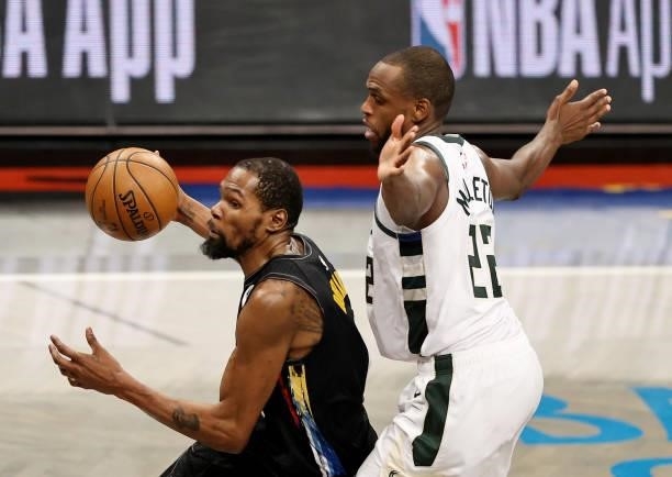Kevin Durant of the Brooklyn Nets drives around Khris Middleton of the Milwaukee Bucks in the second half during game 5 of the Eastern Conference...