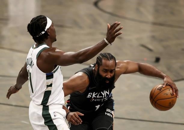 James Harden of the Brooklyn Nets tries to get past Jrue Holiday of the Milwaukee Bucks in the second half during game 5 of the Eastern Conference...