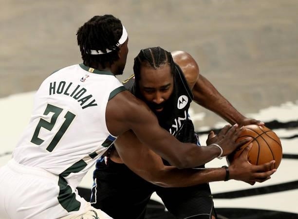 James Harden of the Brooklyn Nets tries to get past Jrue Holiday of the Milwaukee Bucks in the second half during game 5 of the Eastern Conference...