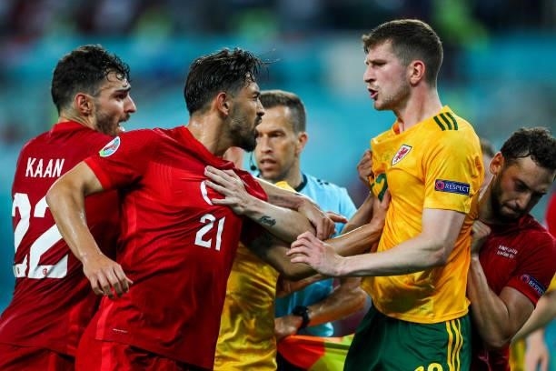 Kaan Ayhan of Turkey, Irfan Can Kahveci of Turkey and Chris Mepham of Wales clash during the UEFA Euro 2020 Championship Group A match between Turkey...