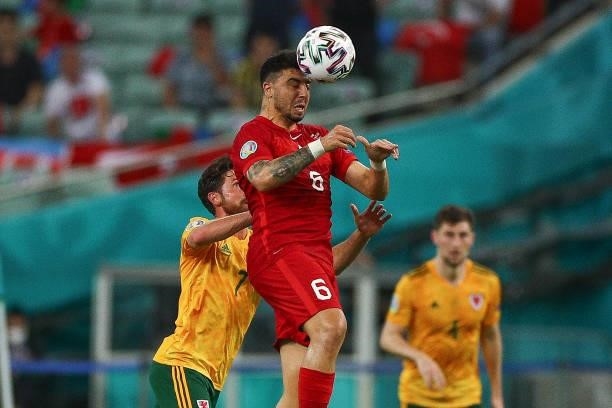 Ozan Tufan of Turkey fights for the ball with Joe Allen of Wales during the UEFA Euro 2020 Championship Group A match between Turkey and Wales at...