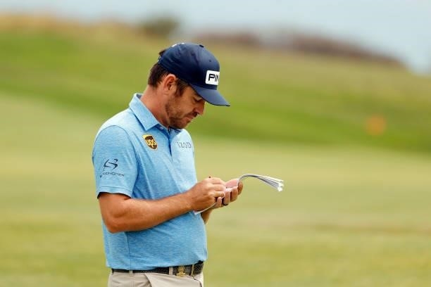 Louis Oosthuizen of South Africa looks at his yardage book on the fourth hole during a practice round prior to the start of the 2021 U.S. Open at...