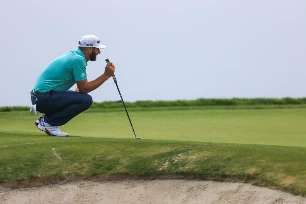 Dustin Johnson of the United States lines up a putt on the fourth green during a practice round prior to the start of the 2021 U.S. Open at Torrey...