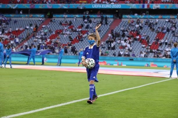 The official ball carrier takes the adidas Uniforia out for kick off ahead of the UEFA Euro 2020 Championship Group F match between France and...