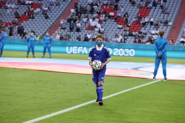 The official ball carrier takes the adidas Uniforia out for kick off ahead of the UEFA Euro 2020 Championship Group F match between France and...