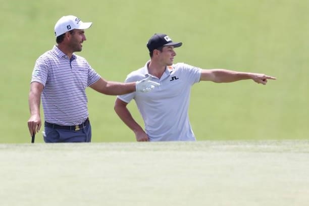 Edoardo Molinari of Italy and Viktor Hovland of Norway stand on the 13th green during a practice round prior to the start of the 2021 U.S. Open at...