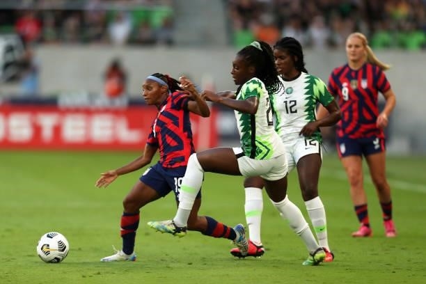 Crystal Dunn of United States fights for the ball with Michelle Alozie of Nigeria during the Summer Series game between United States and Nigeria at...