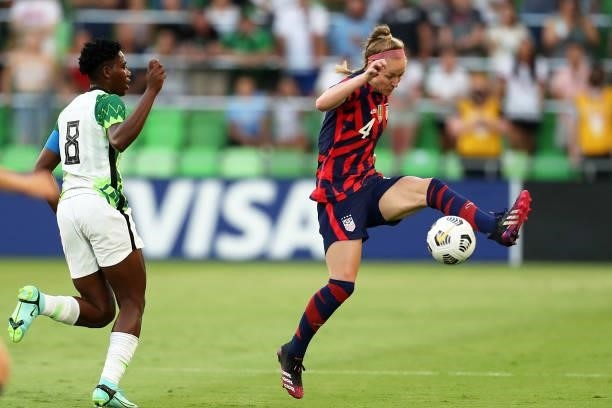 Kristie Mewis of United States controls the ball against Asisat Oshoala of Nigeria during the Summer Series game between United States and Nigeria at...