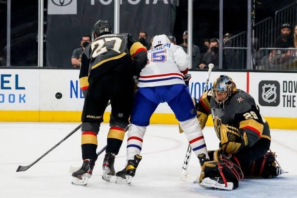 Marc-Andre Fleury of the Vegas Golden Knights tends net as Shea Theodore defends Jesperi Kotkaniemi of the Montreal Canadiens during the first period...