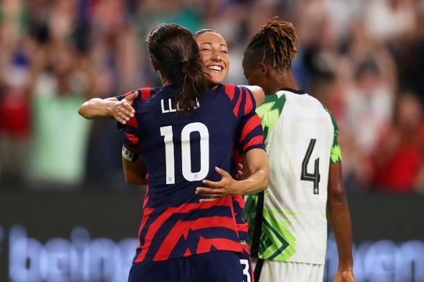 Alex Morgan celebrates with teammate Carli Lloyd after scoring the first goal of her team during the Summer Series game between United States and...