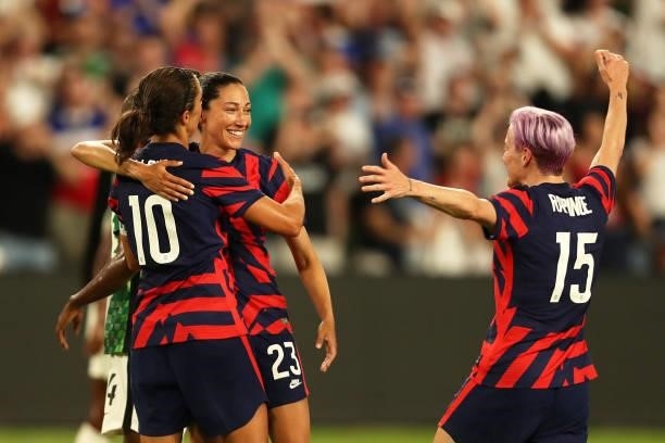 Christen Press of United States celebrates with teammates Carli Lloyd and Megan Rapinoe after scoring the first goal of her team during the Summer...