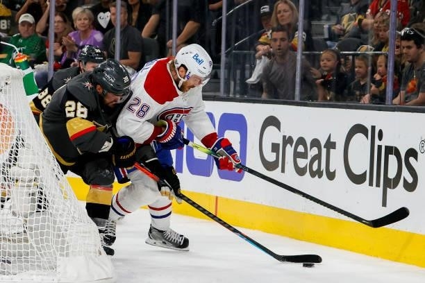 William Carrier of the Vegas Golden Knights and Jon Merrill of the Montreal Canadiens battle for the puck during the second period in Game Two of the...