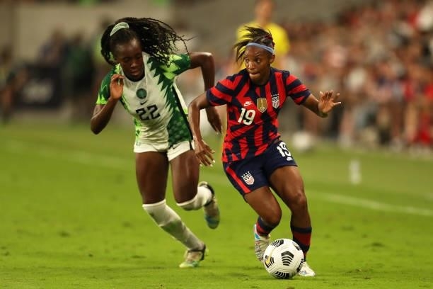 Crystal Dunn of United States controls the ball against Michelle Alozie of Nigeria during the Summer Series game between United States and Nigeria at...