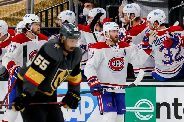 Paul Byron of the Montreal Canadiens is congratulated by his teammates after scoring a goal as Keegan Kolesar of the Vegas Golden Knights reacts...