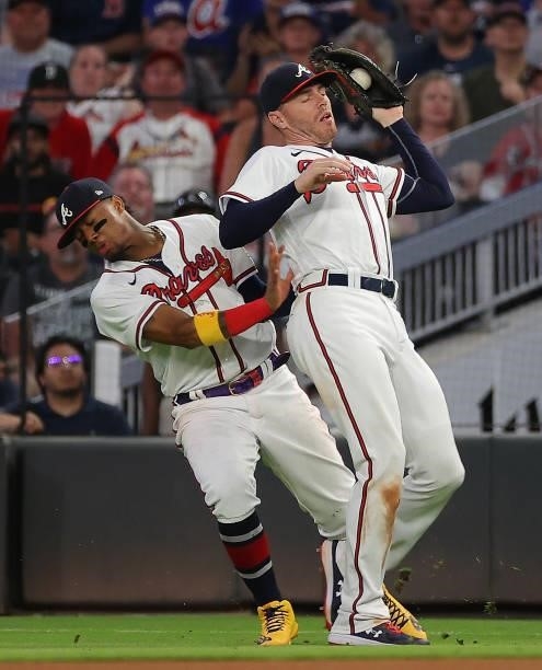 Freddie Freeman of the Atlanta Braves catches a pop out by Hunter Renfroe of the Boston Red Sox as Ronald Acuna Jr. #13 collides with him in the...