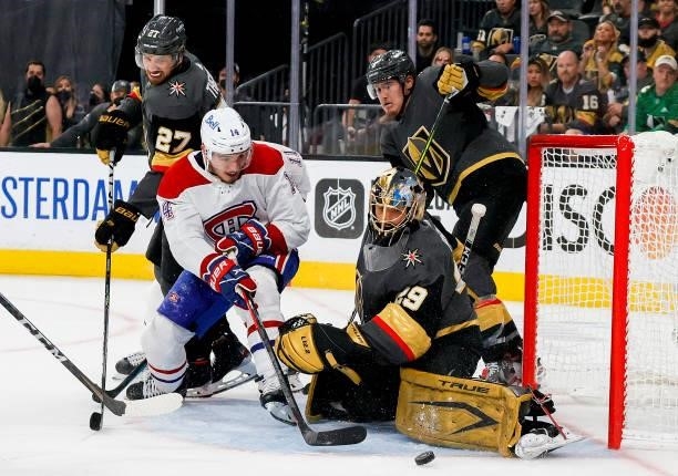Marc-Andre Fleury of the Vegas Golden Knights makes the save against Nick Suzuki of the Montreal Canadiens as Shea Theodore defends during the third...