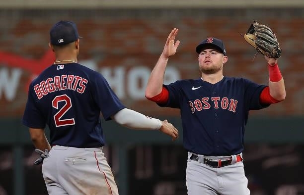 Christian Arroyo and Xander Bogaerts of the Boston Red Sox celebrate their 10-8 win over the Atlanta Braves at Truist Park on June 16, 2021 in...