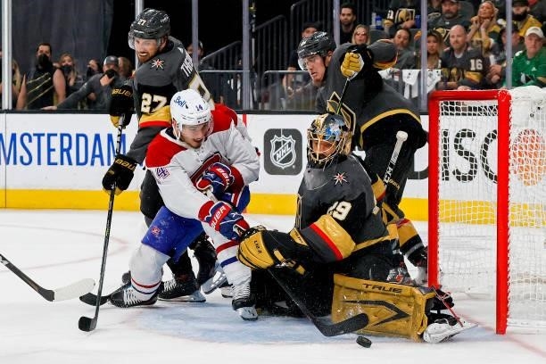 Marc-Andre Fleury of the Vegas Golden Knights makes the save against Nick Suzuki of the Montreal Canadiens as Shea Theodore defends during the third...