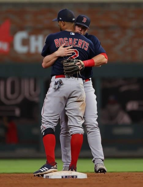 Christian Arroyo and Xander Bogaerts of the Boston Red Sox hug as they celebrate their 10-8 win over the Atlanta Braves at Truist Park on June 16,...