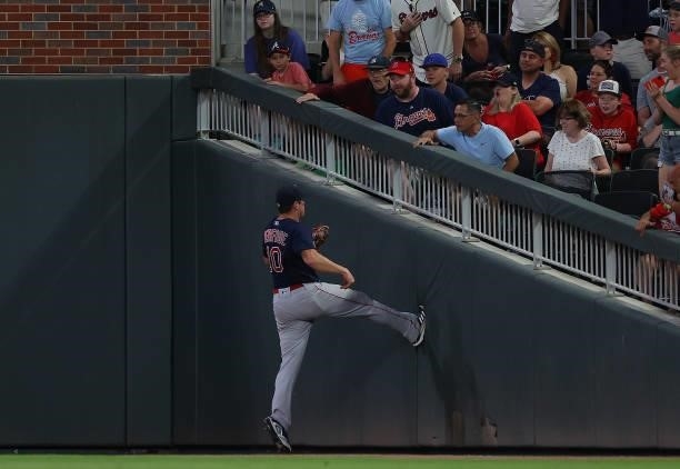 Hunter Renfroe of the Boston Red Sox pushes himself off the sidewall after catching a fly out by Guillermo Heredia of the Atlanta Braves in the fifth...