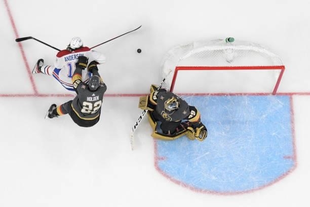 Nick Holden of the Vegas Golden Knights shoves Josh Anderson of the Montreal Canadiens away while Marc-Andre Fleury of the Vegas Golden Knights tends...