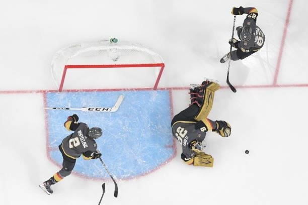 After losing his stick, Marc-Andre Fleury of the Vegas Golden Knights lays out on the ice to block a shot while teammates Zach Whitecloud and Alec...