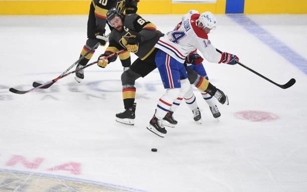 Mark Stone of the Vegas Golden Knights and Nick Suzuki of the Montreal Canadiens collide near center ice in the first period in Game Two of the...