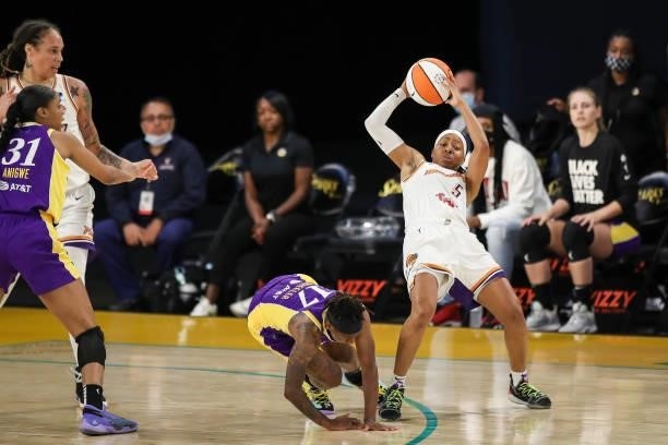 Erica Wheeler of the Los Angeles Sparks and Shey Peddy of the Phoenix Mercury fall after colliding in the second half at Los Angeles Convention...
