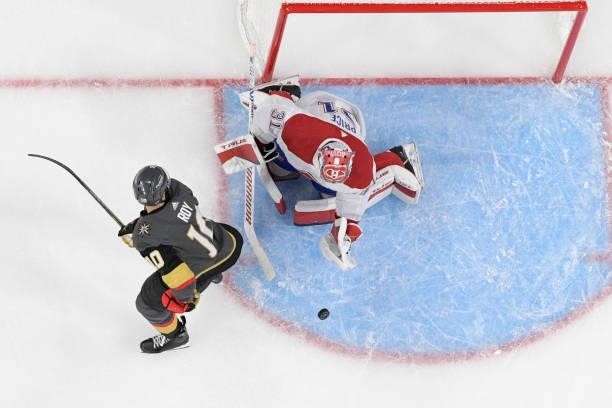Carey Price of the Montreal Canadiens makes a stop while Nicolas Roy of the Vegas Golden Knights looks for a rebound in the second period in Game Two...