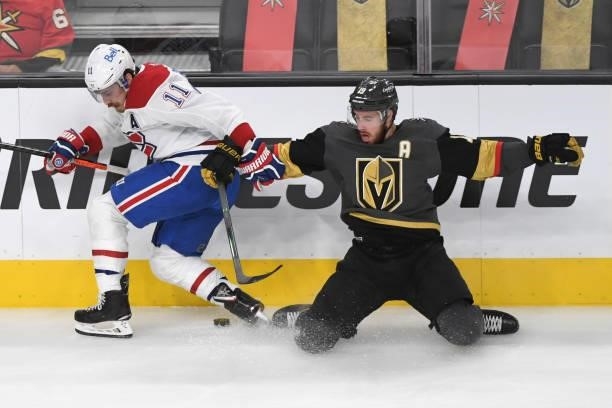 Reilly Smith of the Vegas Golden Knights hits the ice while fighting for the puck with Brendan Gallagher of the Montreal Canadiens in the second...