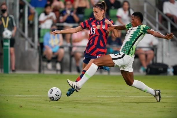 Alex Morgan of the United States controls the ball against Akudo Ogbonna of Nigeria during a WNT Summer Series game at Q2 Stadium on June 16, 2021 in...