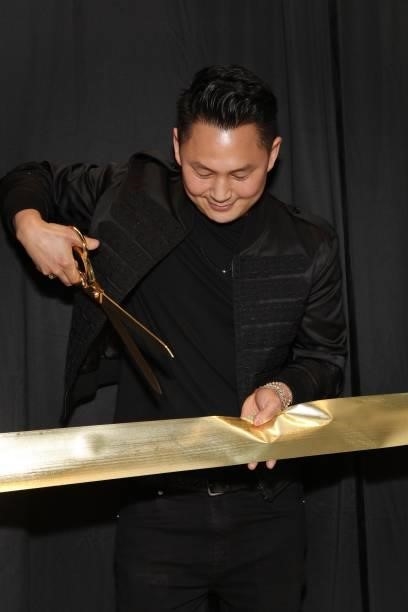 Kyle Chan cuts the ribbon at his store opening at Kyle Chan Design on June 16, 2021 in Los Angeles, California.