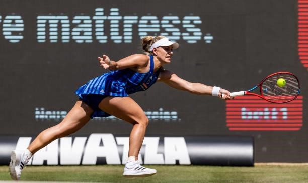 Angelique Kerber of Germany stretches to play a backhand against Victoria Azarenka of Belarus in the women's singles second round match during day 6...