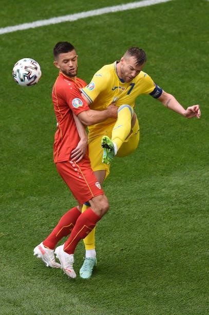 Andriy Yarmolenko of Ukraine is challenged by Visar Musliu of North Macedonia during the UEFA Euro 2020 Championship Group C match between Ukraine...