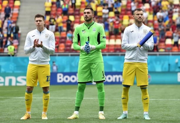Mykola Matviyenko, Georgiy Bushchan and Andriy Yarmolenko of Ukraine stand for the national anthem prior to the UEFA Euro 2020 Championship Group C...