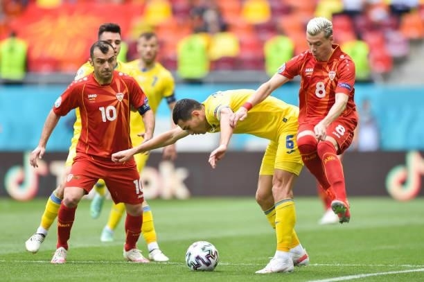 Taras Stepanenko of Ukraine battles for possession with Goran Pandev and Egzijan Alioski of North Macedonia during the UEFA Euro 2020 Championship...