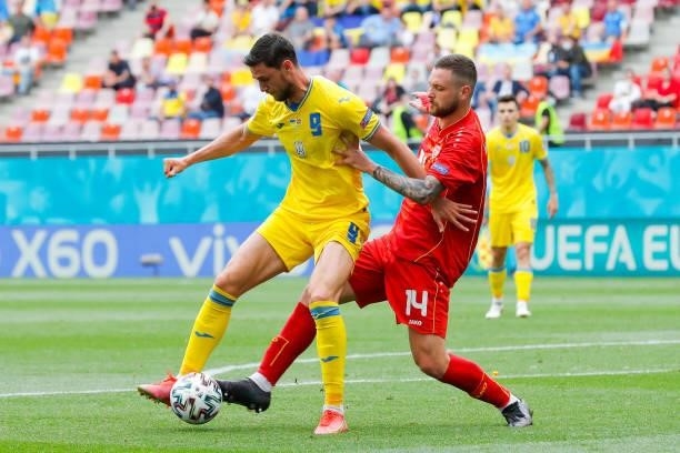 Roman Yaremchuk of Ukraine is challenged by Darko Velkovski of North Macedonia during the UEFA Euro 2020 Championship Group C match between Ukraine...