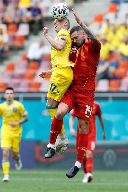 Oleksandr Zinchenko of Ukraine competes for a header with Darko Velkovski of North Macedonia during the UEFA Euro 2020 Championship Group C match...