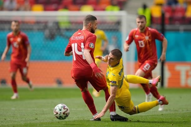 Vitaliy Mykolenko of Ukraine is challenged by Darko Velkovski of North Macedonia during the UEFA Euro 2020 Championship Group C match between Ukraine...
