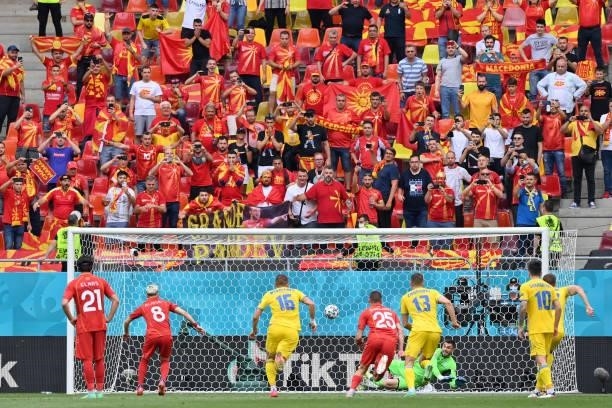 Egzijan Alioski of North Macedonia has a penalty saved by Georgiy Bushchan of Ukraine before scoring their side's first goal during the UEFA Euro...