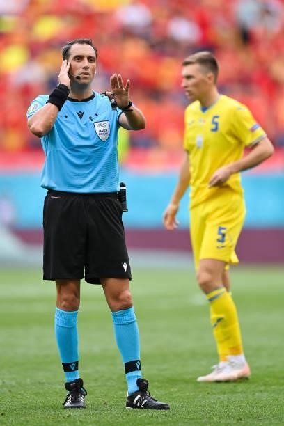 Match Referee, Fernando Andres Rapallini speaks with VAR before a penalty was awarded for Ukraine during the UEFA Euro 2020 Championship Group C...