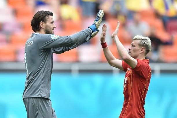 Stole Dimitrievski of North Macedonia celebrates with Egzijan Alioski after saving a penalty during the UEFA Euro 2020 Championship Group C match...