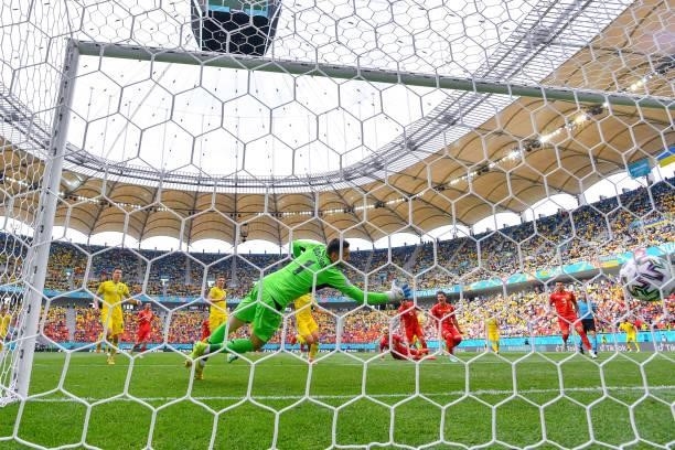 Georgiy Bushchan of Ukraine fails to save as Egzijan Alioski of North Macedonia scores a goal from a rebounded penalty save during the UEFA Euro 2020...