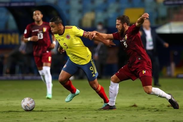 Luis Muriel of Colombia fights for the ball with Francisco Andres La Mantia of Venezuela during a Group B match between Colombia and Venezuela as...