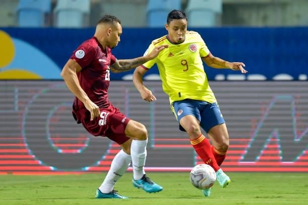 Luis Muriel of Colombia fights for the ball with Luis Martinez of Venezuela during a Group B match between Colombia and Venezuela as part of Copa...