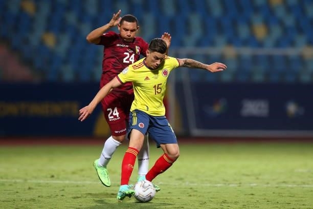 Mateus Uribe of Colombia fights for the ball with Bernaldo Manzano of Venezuela during a Group B match between Colombia and Venezuela as part of Copa...